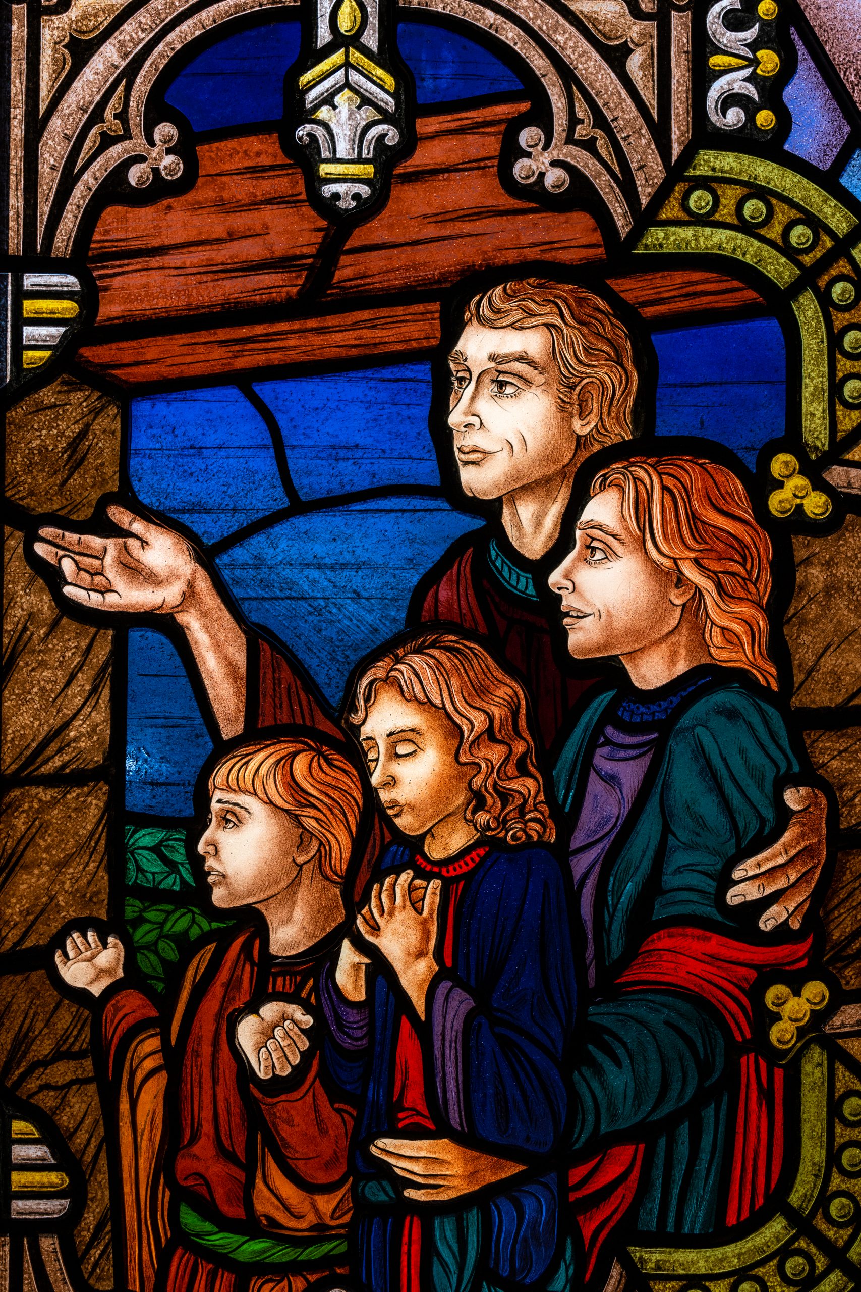 Family worshiping together, in stain glass.